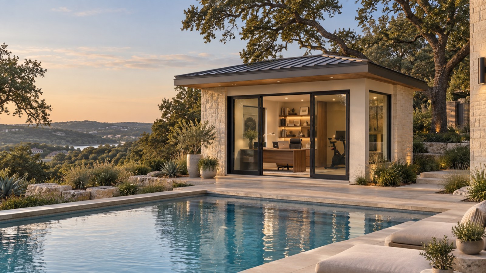 Executive Studio — a stone-and-stucco office pod with a standing-seam roof beside a Hill Country pool